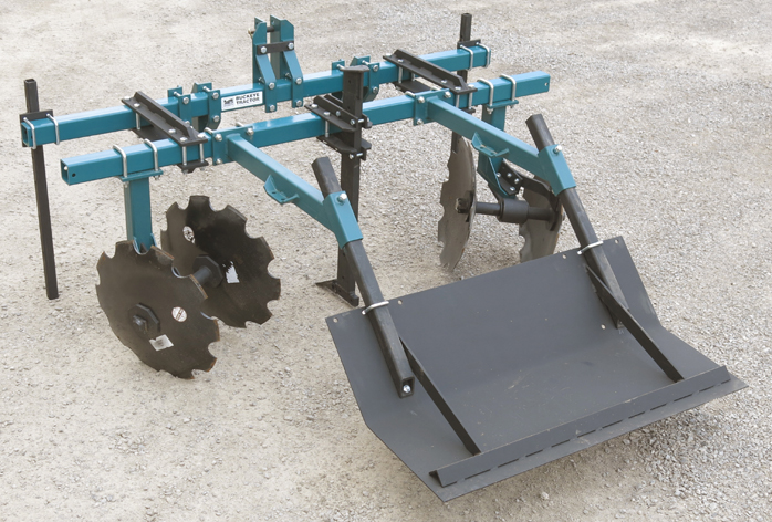 A tractor with a Bedder attached to it.