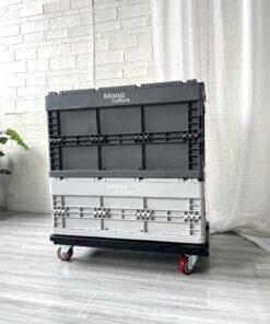 Two gray crates on wheels on a white floor.