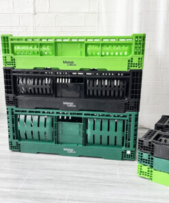 Three green and black plastic crates sitting on a wooden floor.