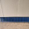 A Roller Conveyor 8'x15" with a blue stripe on it.