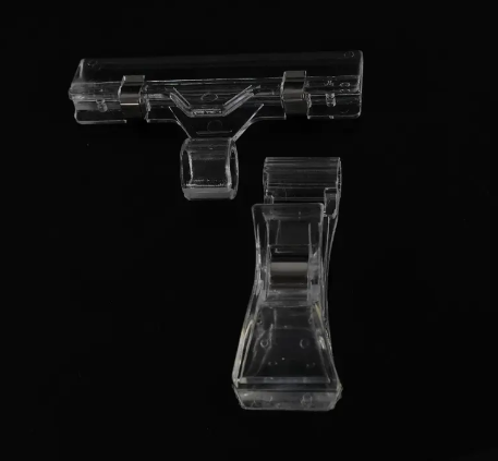 A pair of Sturdy Clips for Mini chalkboards (pack of 20) on a black surface.